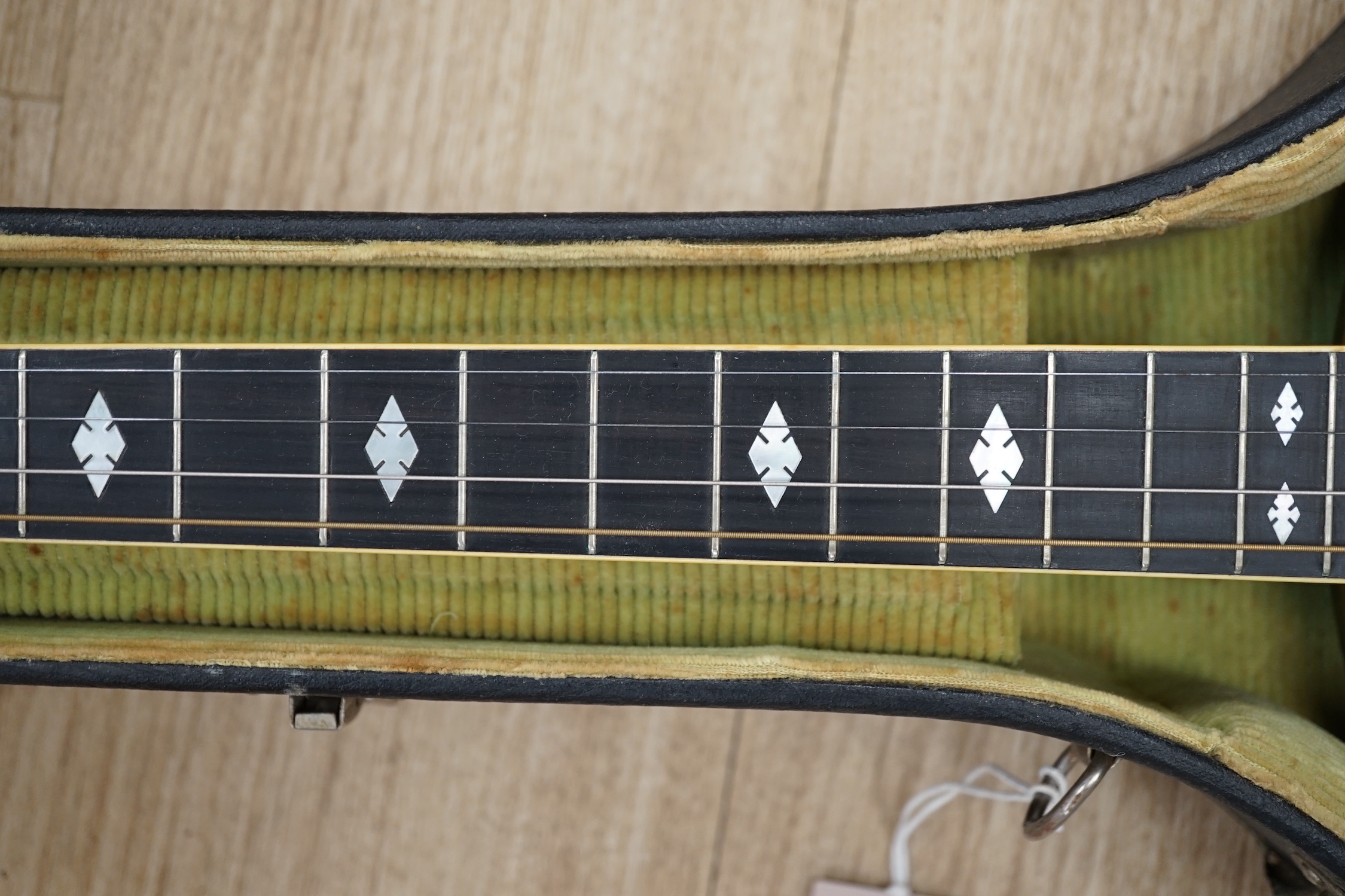 A cased 1920s Ludwig 'Kingston', USA tenor four string banjo, inlaid back, mother of pearl inlay to the fretboard, modern Remo skin, length of body 34cm, overall length 87cm, in a fitted hard case